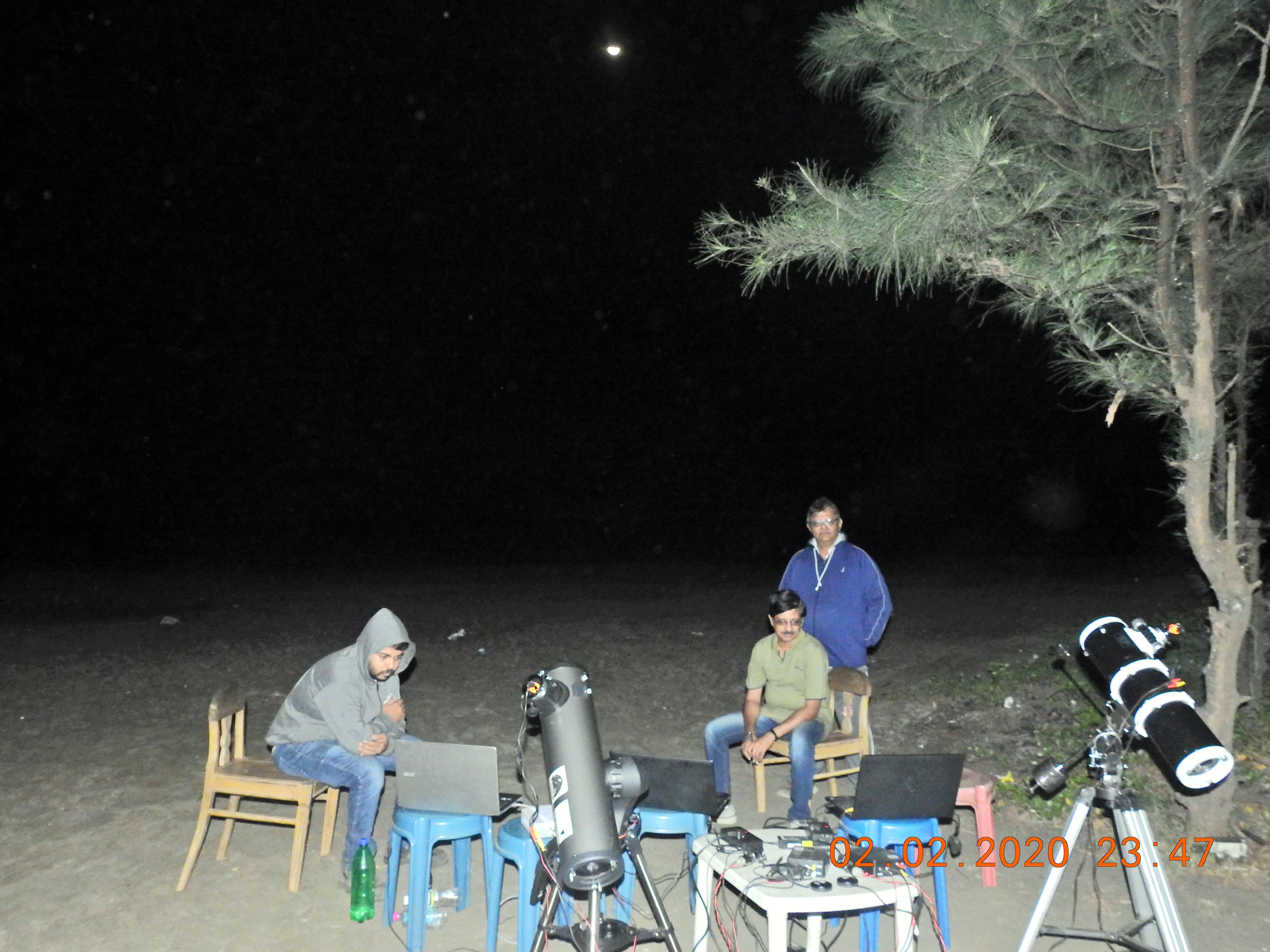 IOTA India observers with telescopes and laptops at a night observing site