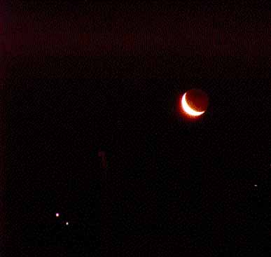 Crescent Venus and a nearby star in a dark sky